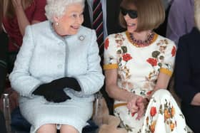 LONDON, ENGLAND - FEBRUARY 20:  Queen Elizabeth II sits next to Anna Wintour as they view Richard Quinn’s runway show before presenting him with the inaugural Queen Elizabeth II Award for British Design as she visits London Fashion Week’s BFC Show Space on February 20, 2018 in London, United Kingdom. (Photo by Yui Mok - Pool/Getty Images)