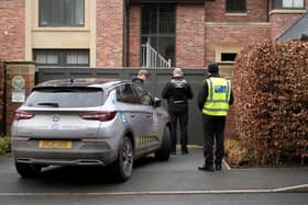 Police officers standing outside Mason Greenwood’s house in February 2022.