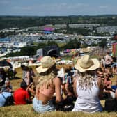 Festivalgoers enjoy the sun and warm weather as they attend Glastonbury 2022 (Photo: ANDY BUCHANAN/AFP via Getty Images)