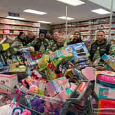 Reese, far right, and his team with some of hundreds of toys they bough from Smyth's Toy Shop