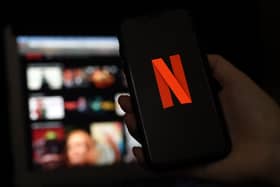 In this photo illustration a computer and a mobile phone screens display the Netflix logo on March 31, 2020 in Arlington, Virginia. (Photo by Olivier DOULIERY / AFP) (Photo by OLIVIER DOULIERY/AFP via Getty Images)