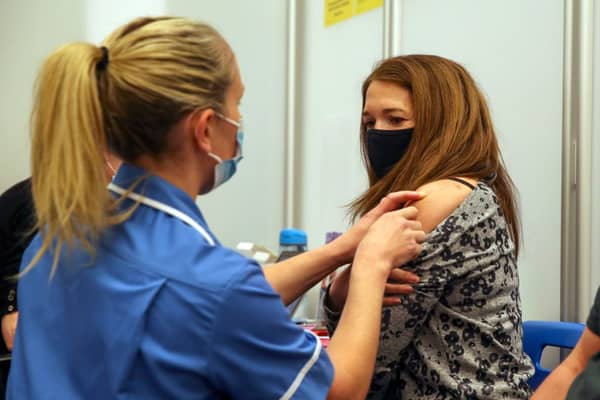 Caroline Nicolls receives an injection of the Moderna Covid-19 vaccine administered by nurse Amy Nash, at the Madejski Stadium, Reading (Getty Images)