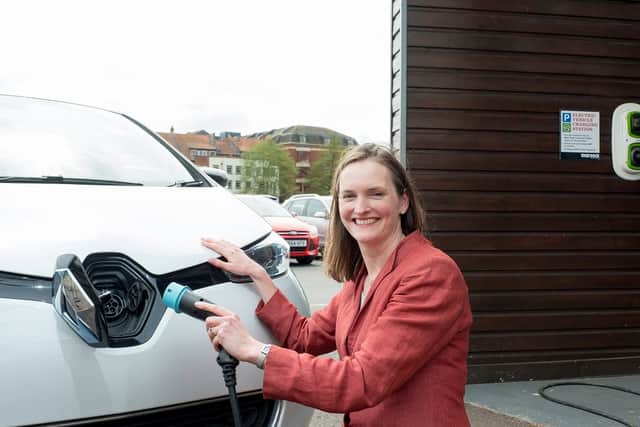 Angela Terry with EV charger to be a common sight outside all new build homes (photo: @JonCraig_Photos)