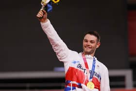 Gold medalist Matthew Walls of Team Great Britain, poses on the podium during the medal ceremony after the Men's Omnium final of the track cycling (Photo by Tim de Waele/Getty Images)