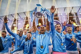 Fernandinho of Manchester City lifts the Premier League Trophy with team mates (Photo by Michael Regan/Getty Images)