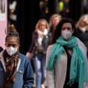 A woman wears a face mask while walking on Oxford Street durng the height of the coronavirus pandemic.