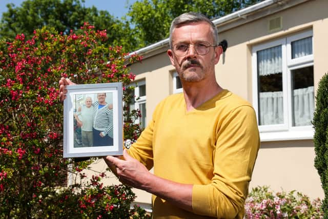 Leigh Blanning with a photo of his late father, John.