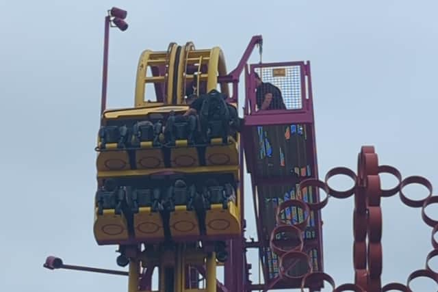 Horrified onlookers watched as rescuers scrambled to the aid of eight terrified people stuck “at the top” of a 22-metre rollercoaster.