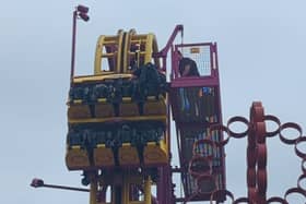 Horrified onlookers watched as rescuers scrambled to the aid of eight terrified people stuck “at the top” of a 22-metre rollercoaster.