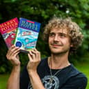 Max Roe with first edition copies of Harry Potter books his mum got him when he was young - one signed by JK Rowling could be worth £10,000.