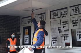 Just Stop Oil protesters fly-post Exeter Labour HQ. The protesters stuck posters and print outs of a letter they had sent to parliamentary candidate Steve Race to the building.