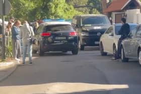 A police car patrols the street outside the Marbella Airbnb on April 25. 