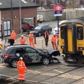 Network Rail staff work to remove an SUV from the track after it was hit by a train on a crossing at Redcar Central, Middlesbrough, on Wednesday May 1 2024. 