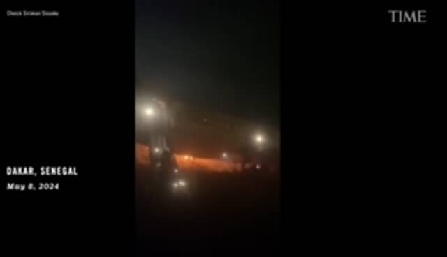 Boeing 737 passengers run from burning plane.