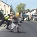 Police officer tackles suspected bike thief to ground.