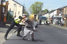 Police officer tackles suspected bike thief to ground.