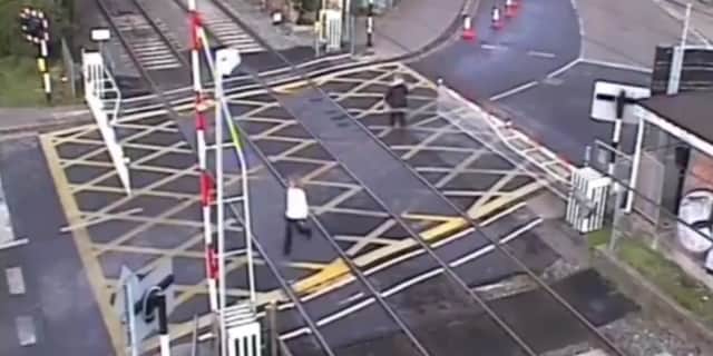 Woman crushed by level crossing barrier.