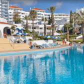 Lounge by the pool at the Grand Muthu Oura View Beach Club