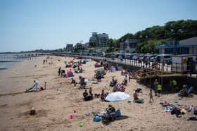 Members of the public relax on the beach in hot weather in Cleethorpes, north east England.