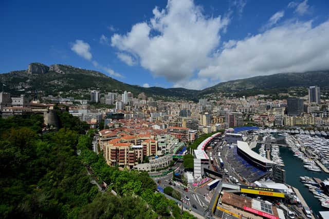 This photograph taken on May 22, 2024 shows a general view of yachts docked at the Monte Carlo harbour in Monaco with the F1 pit lane and the Circuit de Monaco four days ahead of the Formula One Monaco Grand Prix. (Photo b