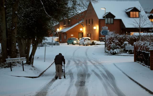 An elderly resident makes his way up a snow covered road in Hartley Wintney, in Hampshire, in 2019 (Photo: ADRIAN DENNIS/AFP via Getty Images)