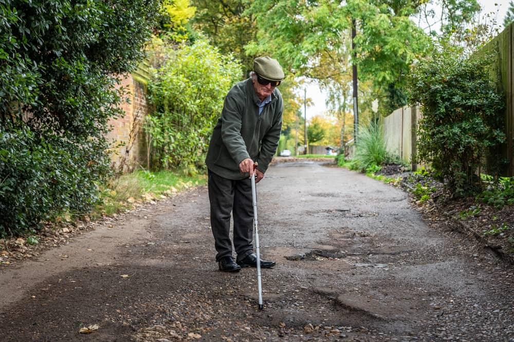 Furious resident Douglas Debnam on Whitebarns Lane in the village of Furneaux Phelham in Hertfordshire, is embroiled in Britain's longest running pothole row.