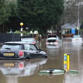 Cars stranded in deep water due to flooding in Stockport.