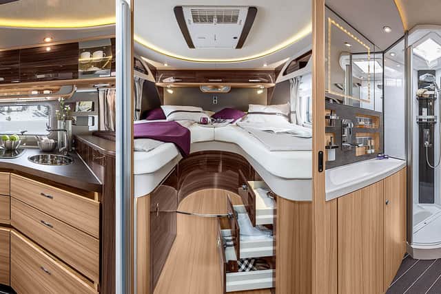 A large kitchen sits in the middle of the motorhome, while the bed can be made into a massive double