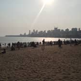 Families gather before sunset on Chowpatty beach in Mumbai