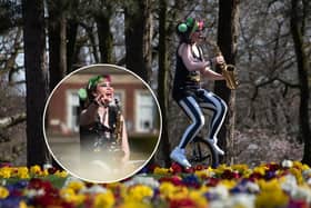Rachel Ward plays the saxophone while riding a unicycle in Stanley Park