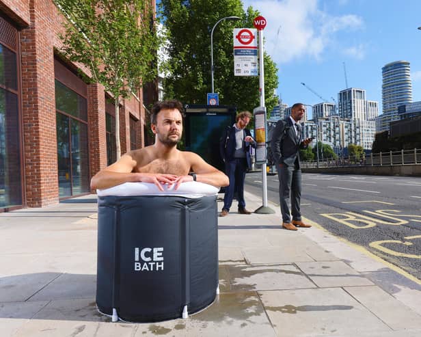 A commuter takes an ice bath at a London bus stop