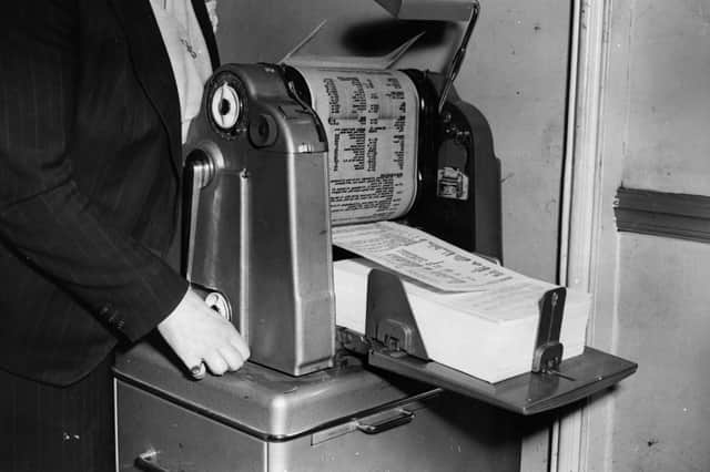 A mimeograph machine being used to make copies of news sheets