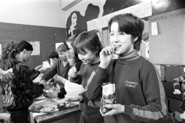 A youngster tucks into a bag of crisps in the 80s