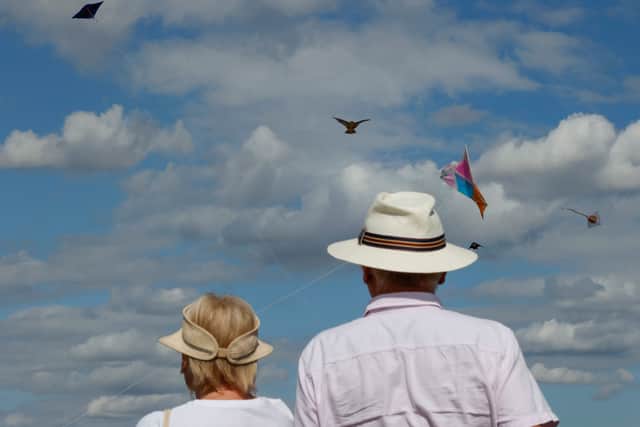 An elderly couple watches as members of the Afghan community and Londoners fly kites on Hampstead Heath. Wage growth has been revised up to 4.8%, meaning pensioners could see a slightly larger state pension rise next April (Photo: CARLOS JASSO/AFP via Getty Images)