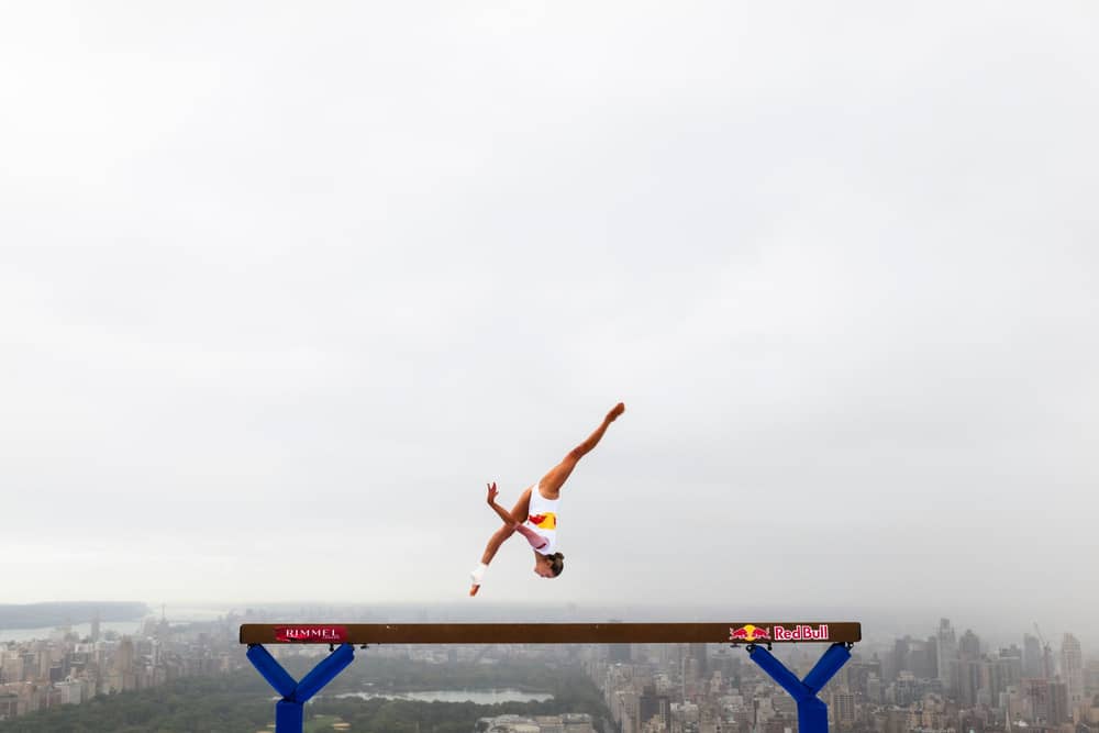Thrill-seeking athlete Lily Smith has performed a daring balance beam routine 52 stories above street level.
