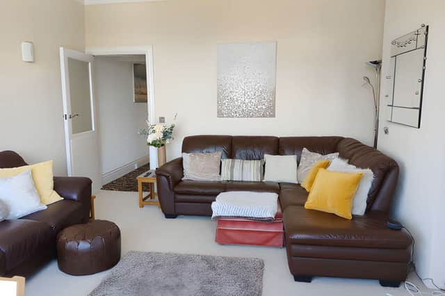 A large bay window is the focal point of the spacious living room