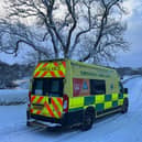 Ambulance tackling snowy roads in winter.