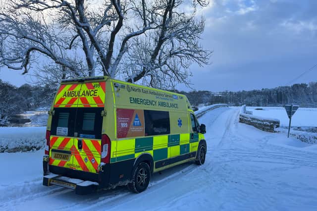 Ambulance tackling snowy roads in winter.