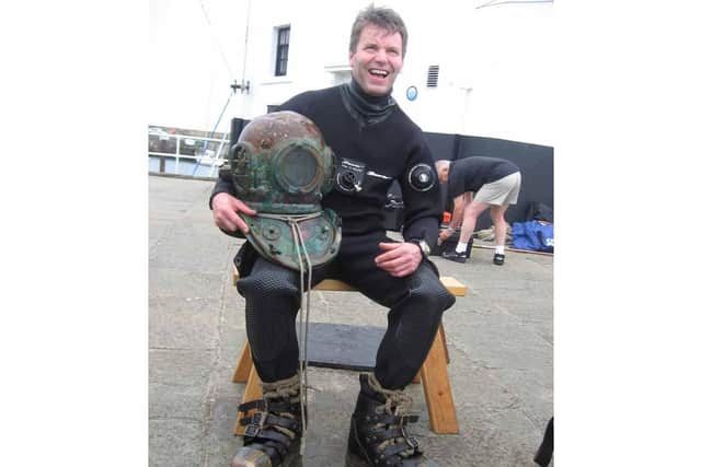 Andy with the Siebe Gorman diving helmet he found on the wreck of The Disperser. Picture: JPI Media