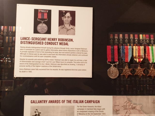 Several heroes of the Green Howards Regiment have their achievements detailed on the walls.