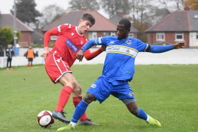 Boro's Kian Spence tries to turn a Radcliffe man. Picture by Morgan Exley.