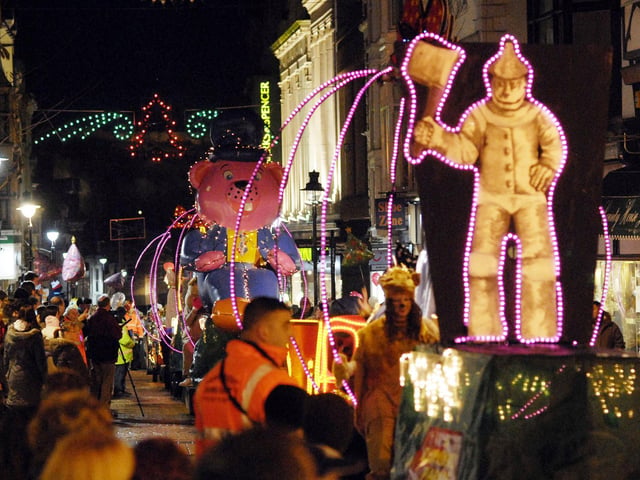 The tin man from the Wizard of Oz takes part in a parade.