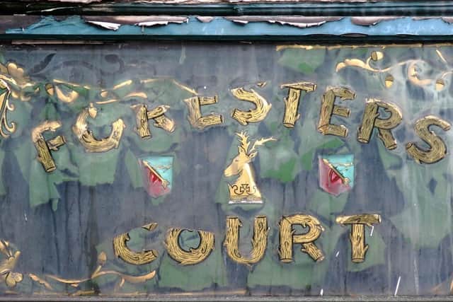 The sign in its tattered state.