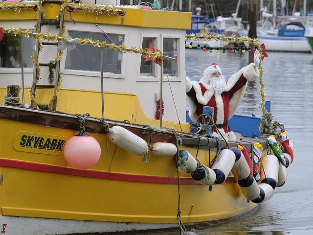 Santa gives the crowds a wave as he arrives.