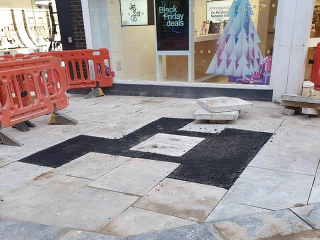 A resident has criticised the way repairs to the town centre's pedestrian area have been carried out.