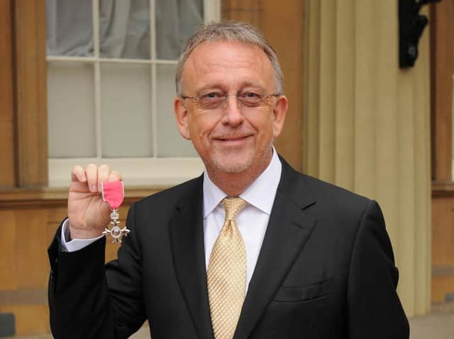 Mr Thomas with his MBE. PA photos.