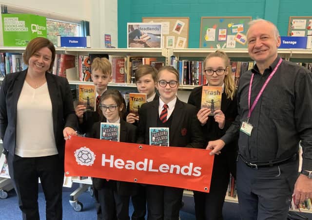 Year 7 Headlands School students take a first look at the new section with assistant headteacher Laura Woodward and library supervisor Paul Hughes.