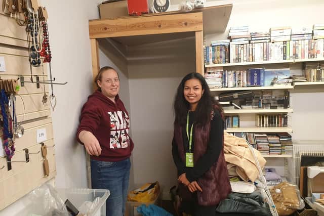Shop manager Lynda Cole with volunteer Prakai Srinadourg by the the empty donation bin.