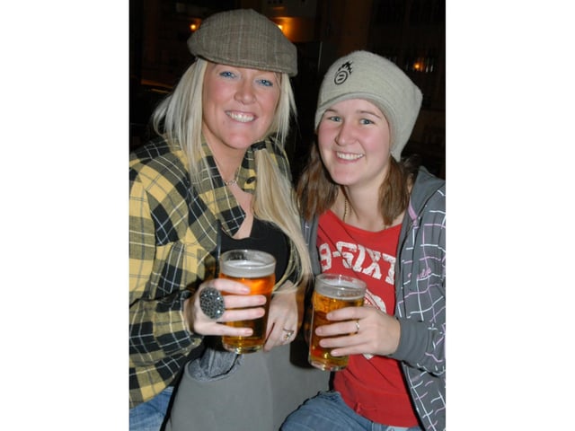 Two girls share a couple of pints.