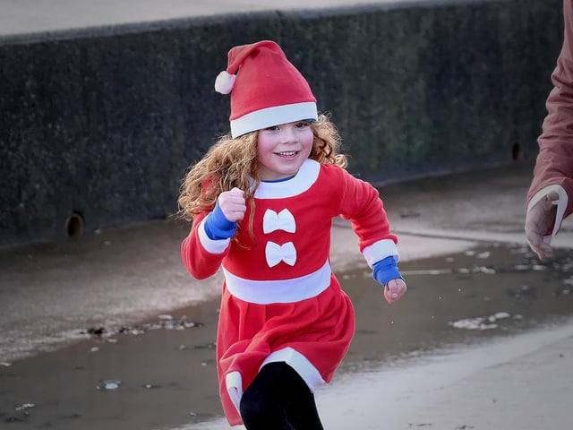 Santa's little helper puts her best foot forward.